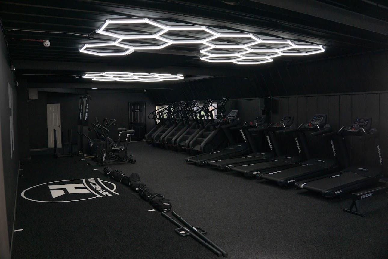 Cardio floor with treadmills and Hype Gym branded floor logo